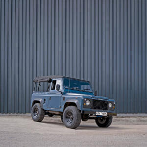a defender sat on 8 spoke black steel wheels