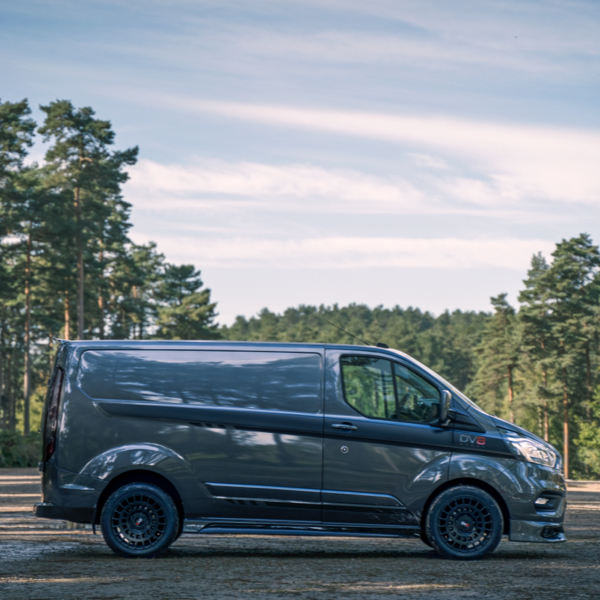 A Ford Transit Custom sat on 4x4 Wheel tyre package in the woods