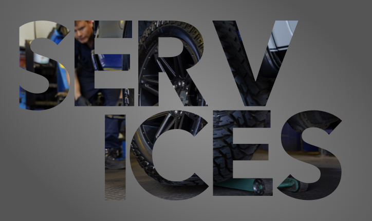 a garge workshop and garage work changing a tyre and wheel with the words service over the top