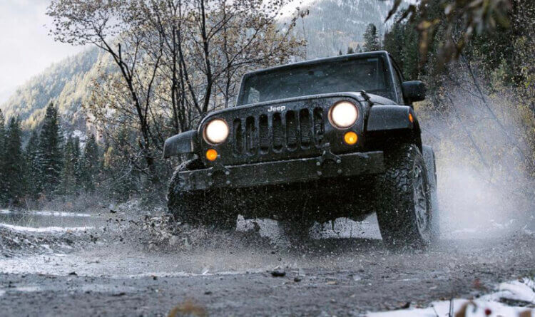 A jeep sat on BFGoodrich All Terrain tyres in bad wet weather