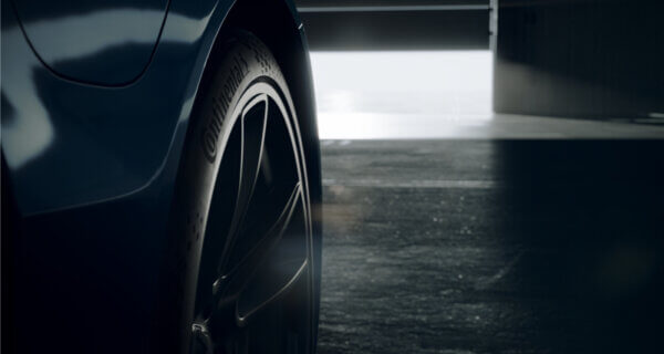 A Continental Sport Contact in dark setting with a light coming under the garage door