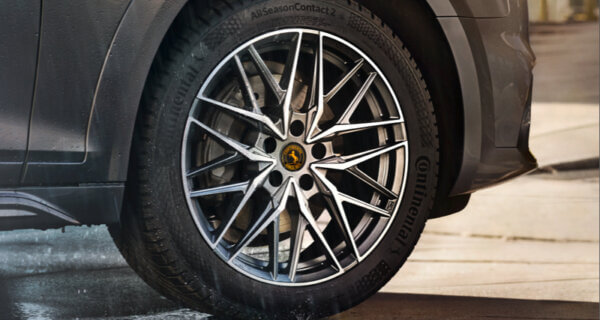 A Conti Tyres image of the All Season Contact 2 tyre sat on a spoked alloy wheel