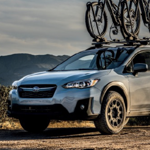 A car sat on Mild all terrain tyres on a gravel track showing What Are Mild all terrain Tyres?