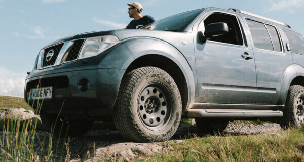 a 4x4 Nissan sat on a rocky hill