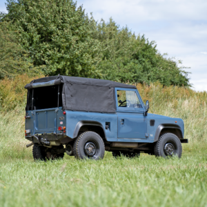 a defender sat on classic tubeless black steel wheels